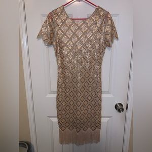 Flapper dress with bottom fringe. Brand:Verty. Size medium, color gold.